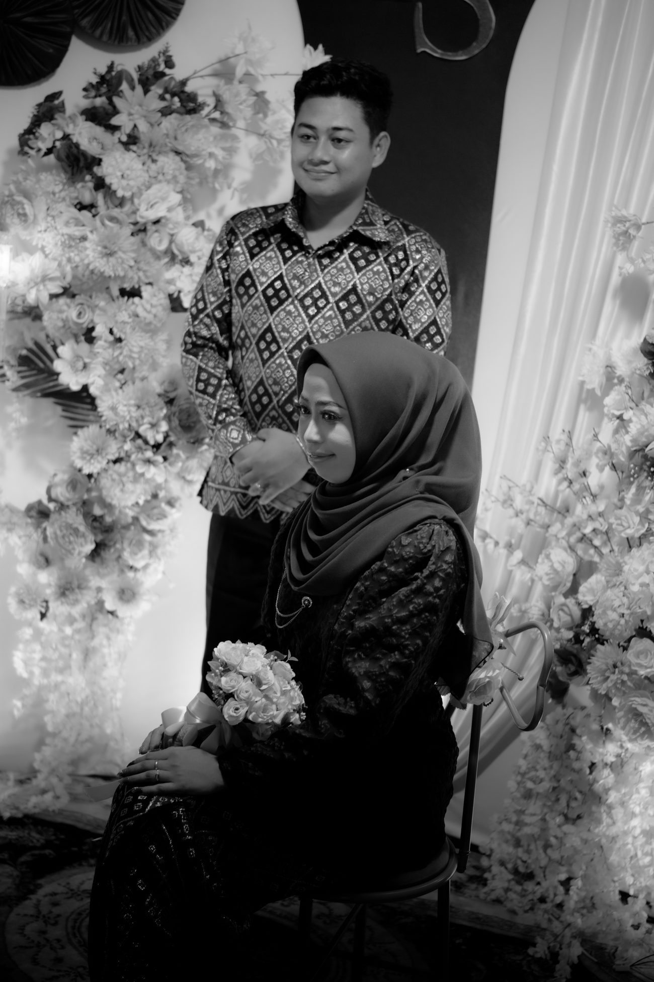 Beside her.